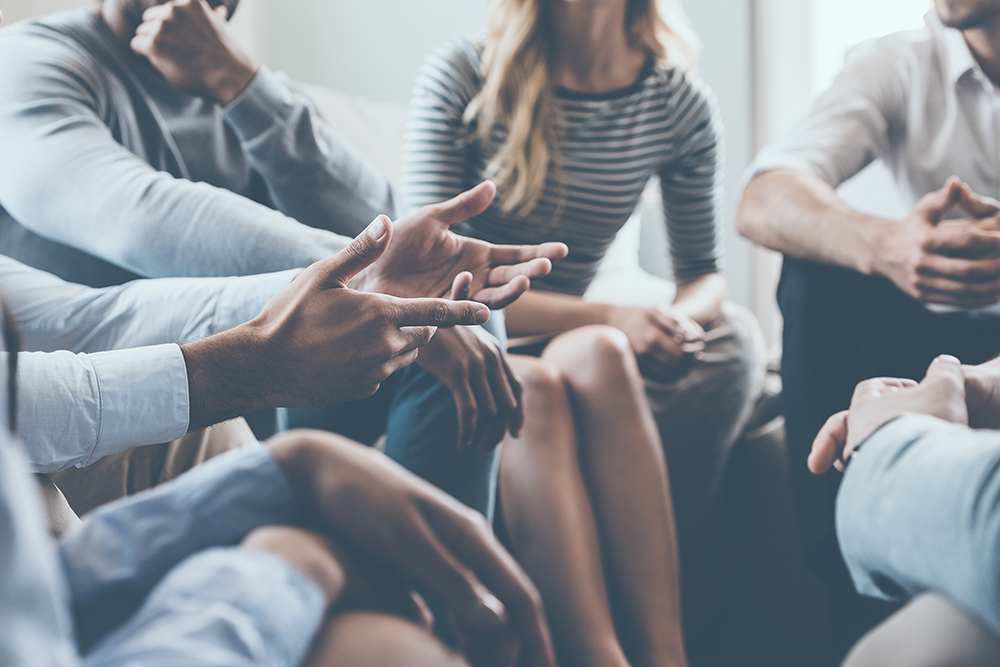 people sitting in group talking