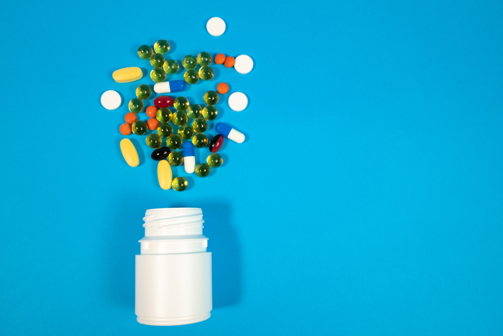 Illustration of bottle with a variety of pills