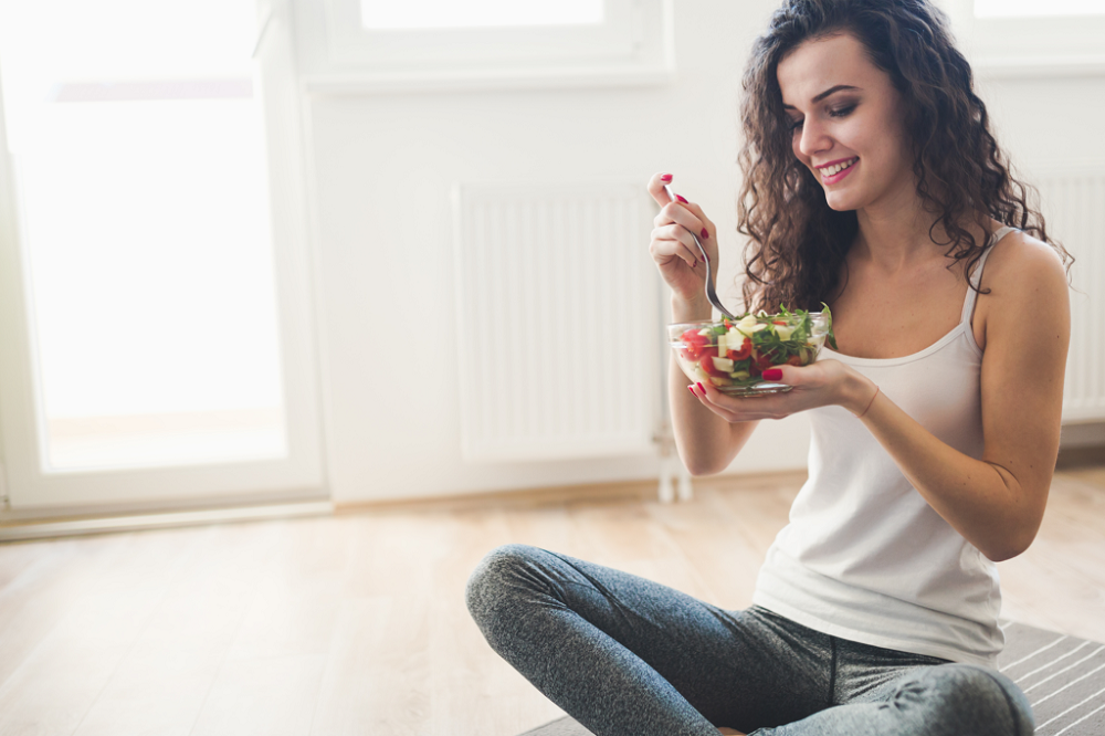 Image of young woman eating a salad