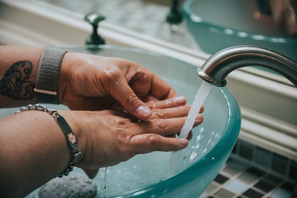 Person washing their hands in sink